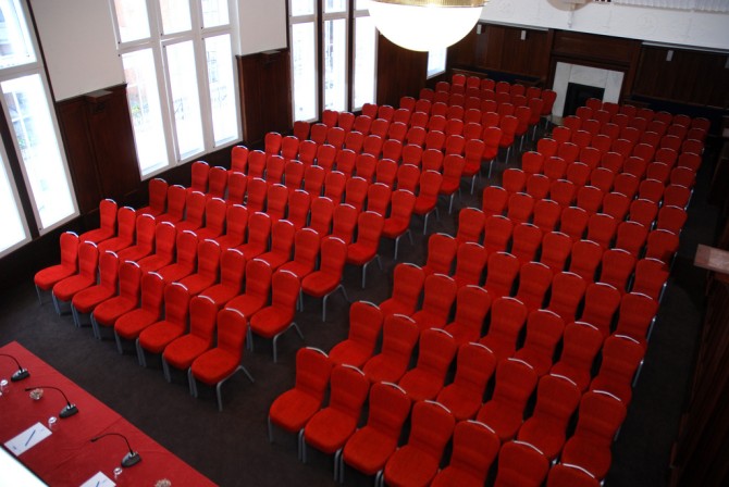 council chamber, theatre, red chairs, conference table