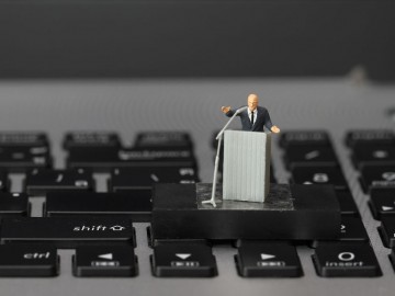 online conference concept-miniature speaker at Business Conference on laptop computer